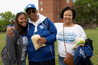 Smiling family of three wearing UK gear