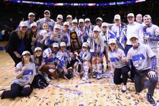 2021 UK Volleyball team celebrating on the floor of Rupp Arena