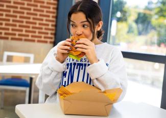 woman eating hamburger