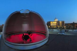 Red bubble on top of building with library in the background