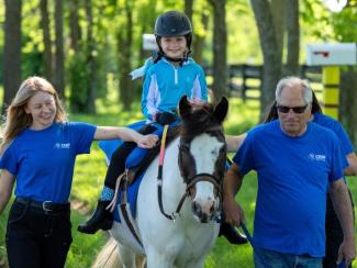 child riding a horse
