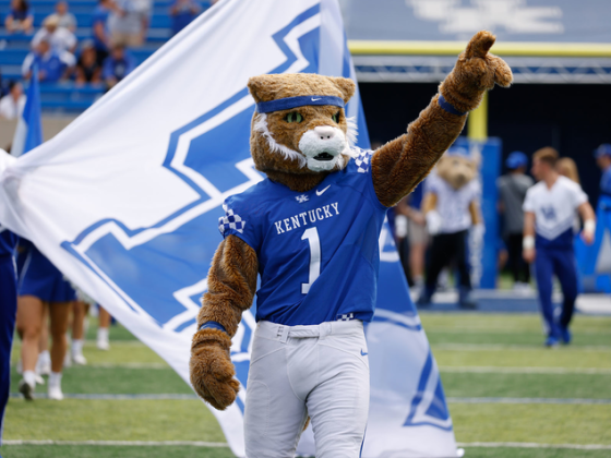 Wildcat mascot costume pointing to the sky